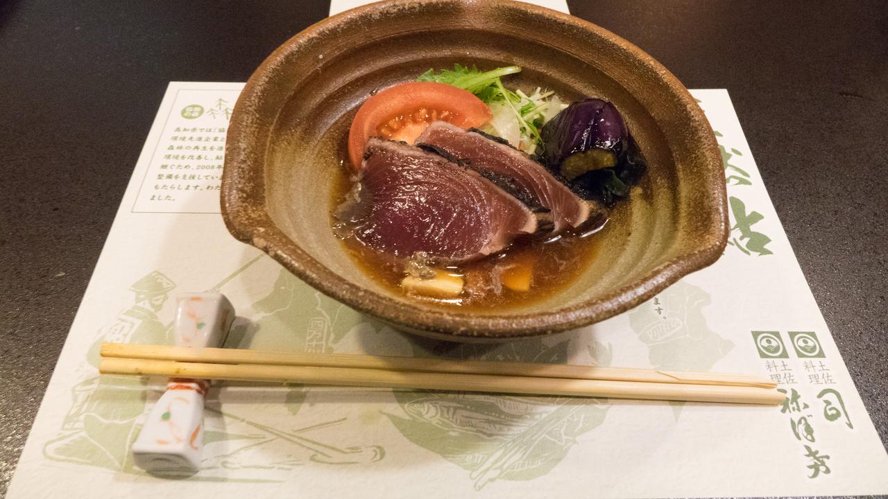 Bowl of food with chopsticks