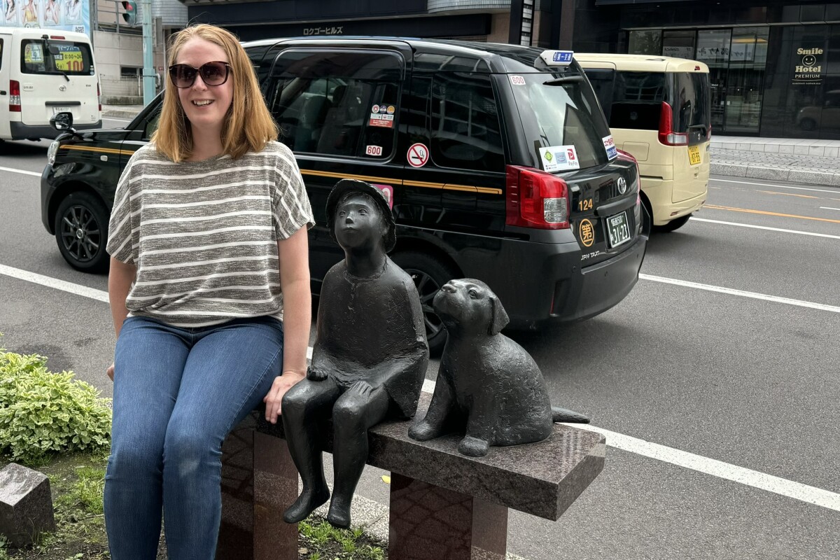 Anna sitting with street art statues Japan, Selective Asia