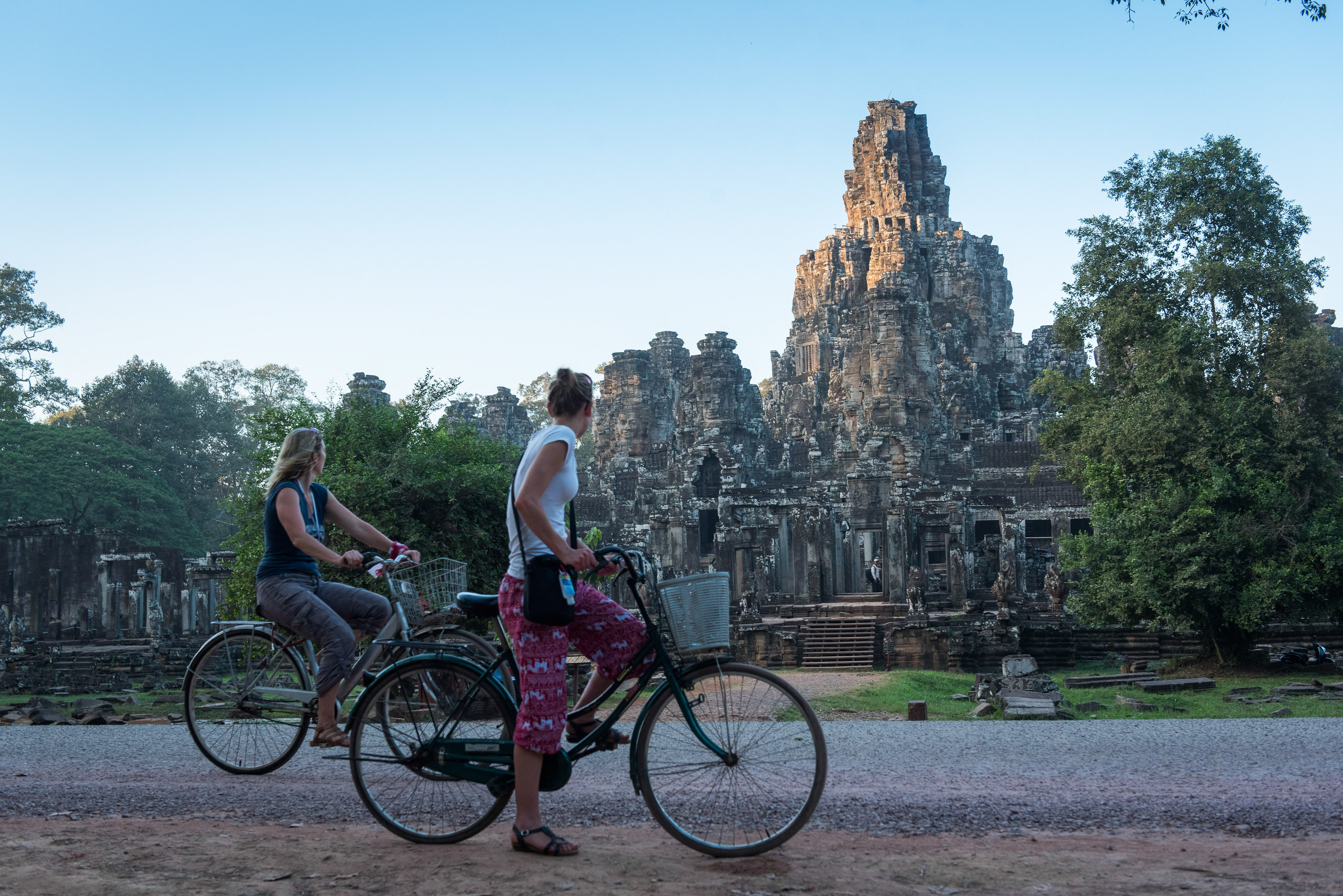 Two girls cycling in Angkor Wat 