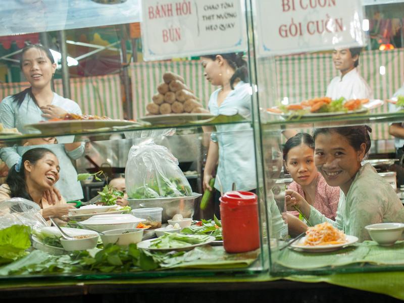 girls laughing on cafe window in ho chi minh city