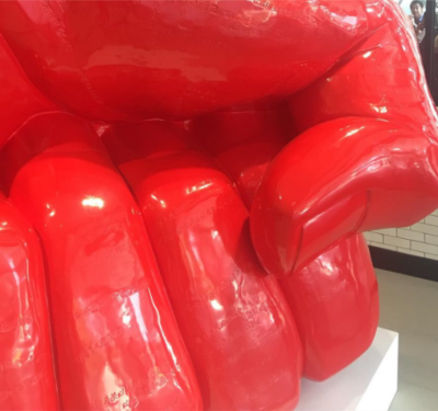 Art installation: a giant red fist smashing into the floor